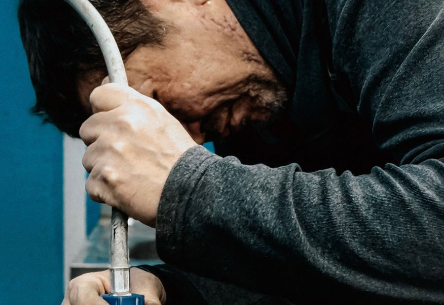 Technician servicing a well pump and pressure line on a Williamson County property